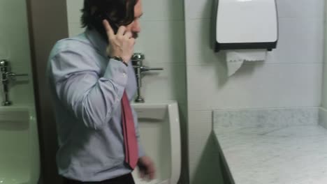 Angry-Manager-Shouting-On-Mobile-Telephone-In-Workplace-Lavatories