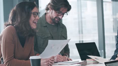 Senior-businesswoman-talking-with-colleagues-smiling-in-meeting