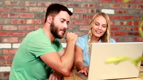 Photo-editors-working-at-desk-using-laptop