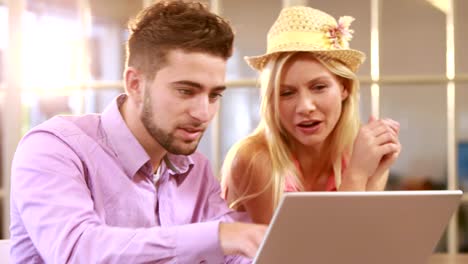 Smiling-casual-business-workers-working-with-laptop