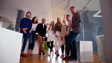 multicultural-group-of-employees-standing-together-during-office-studio-meeting.