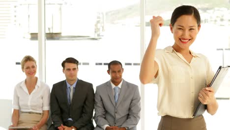 Businesswoman-giving-thumbs-to-camera