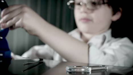 4k-Biology-Student-Child-preparing-his-Microscope-for-Testing