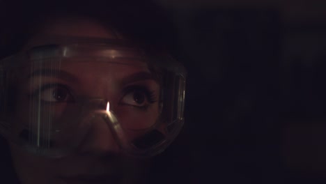 4k-Abstract-Shot-of-a-Woman-Face-and-Glasses-with-Projector-Reflection-of-Fire