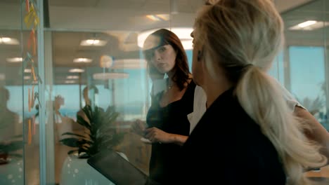 Business-team-pointing-and-discussing-over-sticky-notes