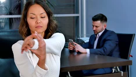 Portrait-of-a-young-woman-stretching-hands-in-office