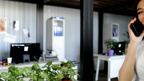 Asian-Business-Woman-Talking-On-Phone-Call-Holding-Documents-In-Modern-Creative-Office-Beautiful-Businesswoman-Working