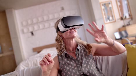 Senior-woman-having-fun-with-virtual-reality-simulator-at-home