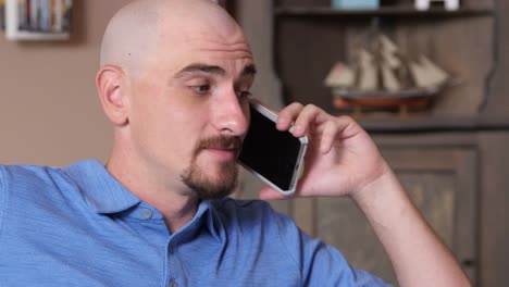 Man-at-home-talking-on-cell-phone