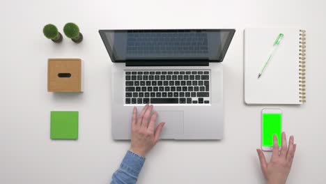 Overhead-Footage-Of-Businesswoman-Using-Laptop-And-Smartphone