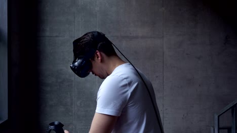 Man-Using-Virtual-Reality-Headset-with-Motion-Controllers