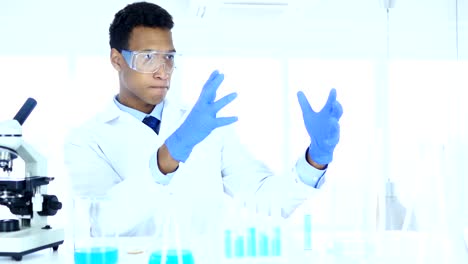 Afro-American-Scientist-imaginating-New-idea-in-Laboratory