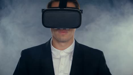 Businessman-get-experience-in-using-VR-headset-in-smoky-dark-room