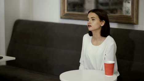 Woman-stands-up-from-sofa-and-walks-away