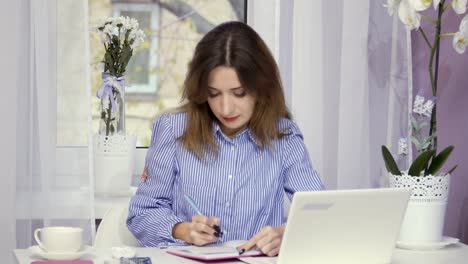 Stylish-businesswoman-works-near-the-window