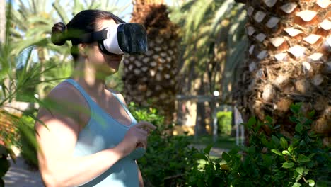 Video-of-woman-exploring-virtual-reality-in-tropical-resort-in-4k