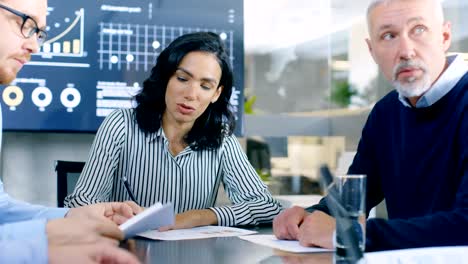 Group-of-Smart-and-Respectable-Business-People-Work-on-a-Problem-Solving-in-the-Meeting-Room.-Diverse-Group-of-Mixed-Ethnicity-and-Gender-Explore-Potential-for-Company-Future-Development.