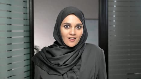 A-young-Arab-girl-in-a-hijab-is-surprised,-indignant-and-looks-at-the-camera.-60-fps