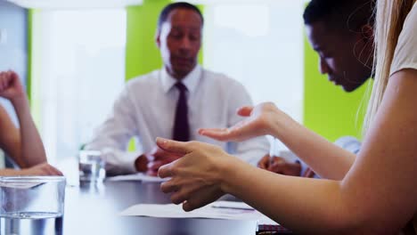 Focus-on-woman’s-hands-gesturing-at-a-business-meeting