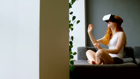 Woman-using-virtual-reality-headset-in-living-room-4k