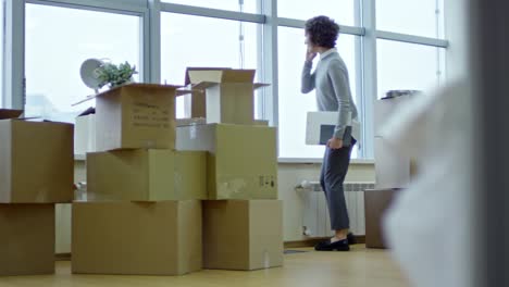 Female-Manager-Talking-on-Phone-in-New-Office