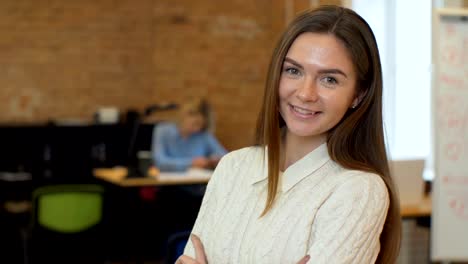 Portrait-of-successful-Businesswoman-entrepreneur-working-at-busy-office-smiling