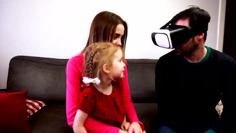 The-father-of-the-family-sits-in-the-virtual-reality-helmet