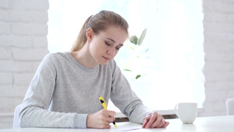 Young-Woman-Writing-Documents-in-Office,-Paperwork