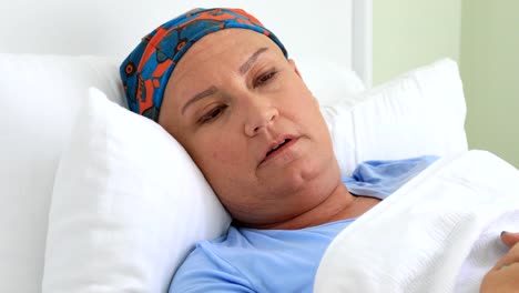 Middle-aged-woman-with-cancer-laying-on-a-bed