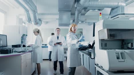 Team-of-Research-Scientists-Working-On-Computer,-with-Medical-Equipment,-Analyzing-Blood-and-Genetic-Material-Samples-with-Special-Machines-in-the-Modern-Laboratory.