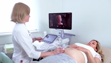 In-the-Hospital,-Close-up-Shot-of-the-Doctor-does-Ultrasound-/-Sonogram-Procedure-to-a-Pregnant-Woman.