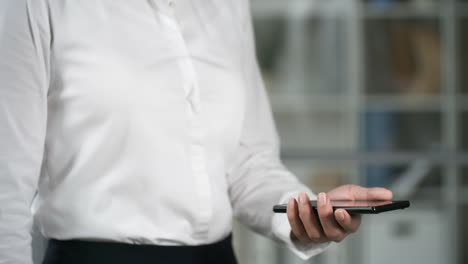 Businesswoman-Tapping-on-Mobile-Phone