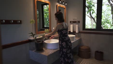 Woman-washing-hands-at-home