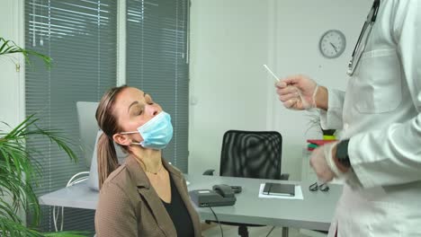 attractive-young-woman-having-a-PCR-nasal-test-with-swab-for-coronavirus-COVID-19-virus-detection-testing-in-doctor-office