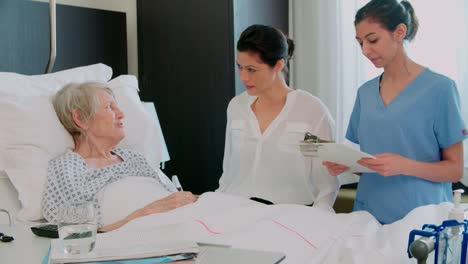 Family-Visit-To-Grandmother-In-Hospital-Bed