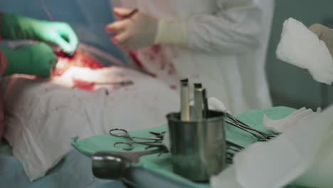 Surgeons-sew-up-stomach-woman-by-needle-and-thread.-Cesarean-section.-Nurse