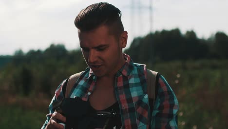 Boy-with-backpack-looking-in-virtual-reality-glasses-at-road.-Funny.-Playing