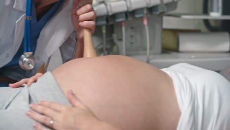 Doctor-Listening-to-Pregnant-Belly-with-Fetoscope
