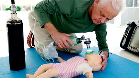 Male-paramedic-giving-oxygen-to-a-dummy