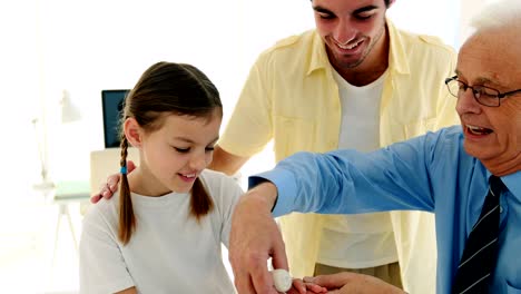 Doctor-applying-bandage-to-girls-hand