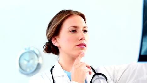 Female-doctor-examining-a-x-ray-report