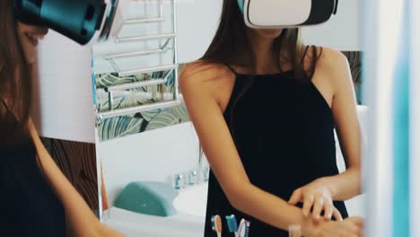 Girl-stay-in-front-of-mirror-in-bathroom-with-virtual-reality-glasses-on-head