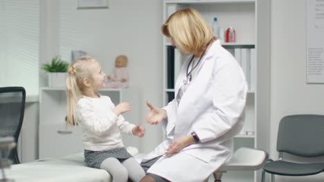 Female-Doctor-Does-Throat-Examination-of-a-Little-Girl.-After-Examination-They-Do-High-Five.