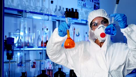 Woman-holds-in-hands-of-two-large-flasks.