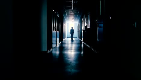 Scientist-in-protective-suit-going-through-dark-corridor