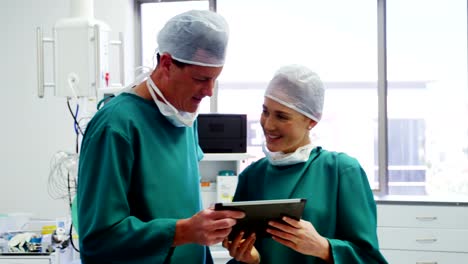 Doctor-and-colleague-discussing-over-digital-tablet