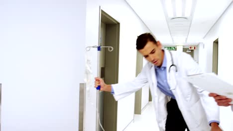 Doctors-pushing-emergency-stretcher-bed-in-corridor