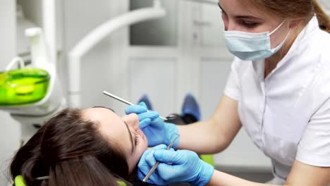 Young-female-dentist-is-examining-patient's-teeth.-Healthy-teeth-and-dental-healthcare.