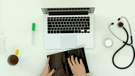 Female-doctor-hands-arranging-things-at-work-desk