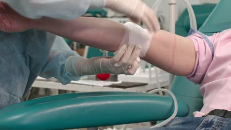 Nurse-Wrapping-Gauze-around-Arm-of-Donor